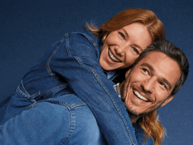 Casal sorridente usando looks jeans em clima descontraído, representando conexão e principais dúvidas sobre jeans no dia a dia